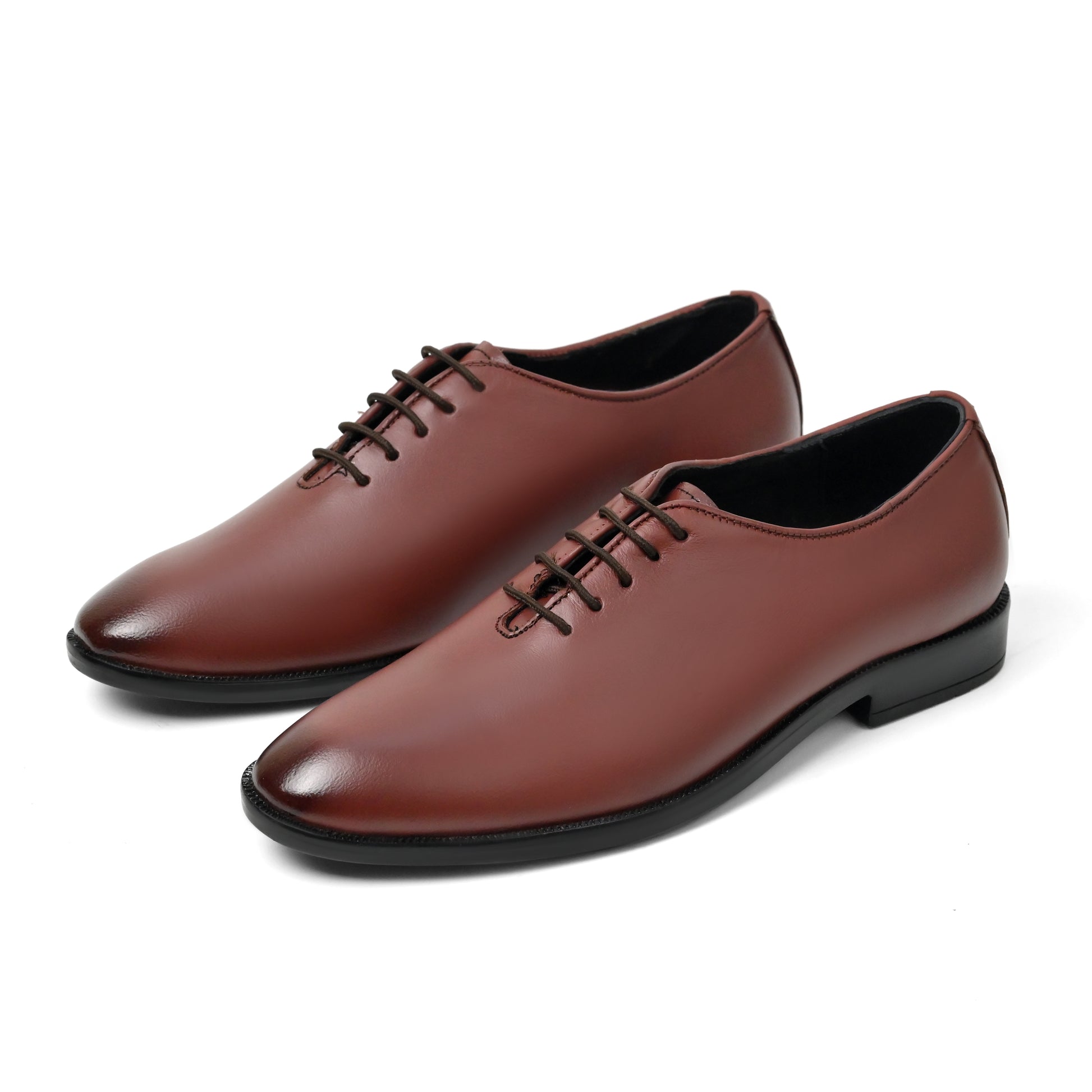 Dagga Pair of brown leather shoes on a white background
